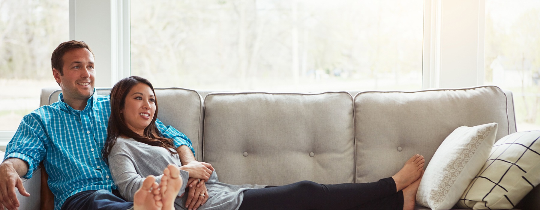 man and woman sitting on a couch